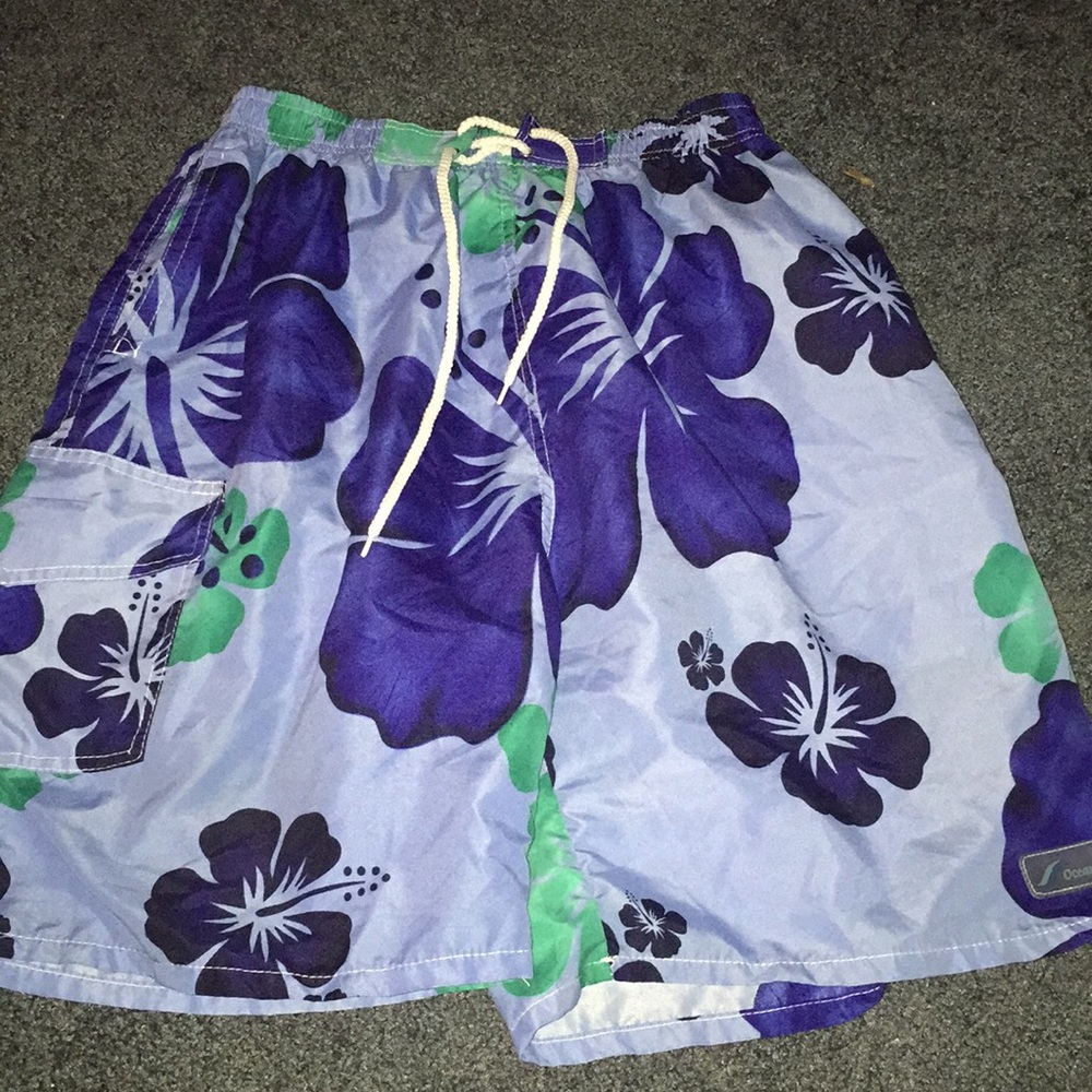 blue swim trunks with blue and green flowers